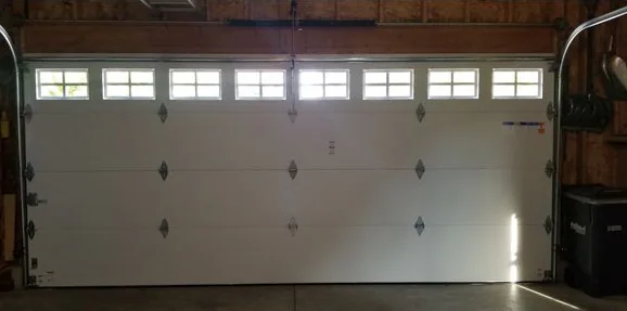 Inside the same garage: a white double door with a row of windows across the top section.